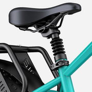Close-up of a bicycle seat with suspension on a teal frame.