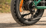 Close-up of a motorcycle wheel with a focus on the tire and chain.