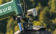 Close-up of a green ATV with a light on a blurred natural background