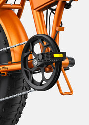 Close-up of an orange bicycle with a chain and gear system on a white background