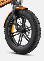 Close-up of a bicycle wheel with thick tire on a light gray background
