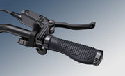 Close-up of a motorcycle handlebar with throttle and brake lever on a gradient background