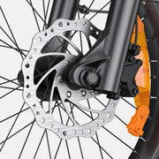 Close-up of a bicycle disc brake system with an orange brake lever on a white background