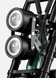 Close-up of a motorcycle headlight assembly with visible wiring on a gray background