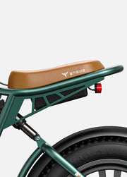 Close-up of a green electric bike with a brown seat on a white background